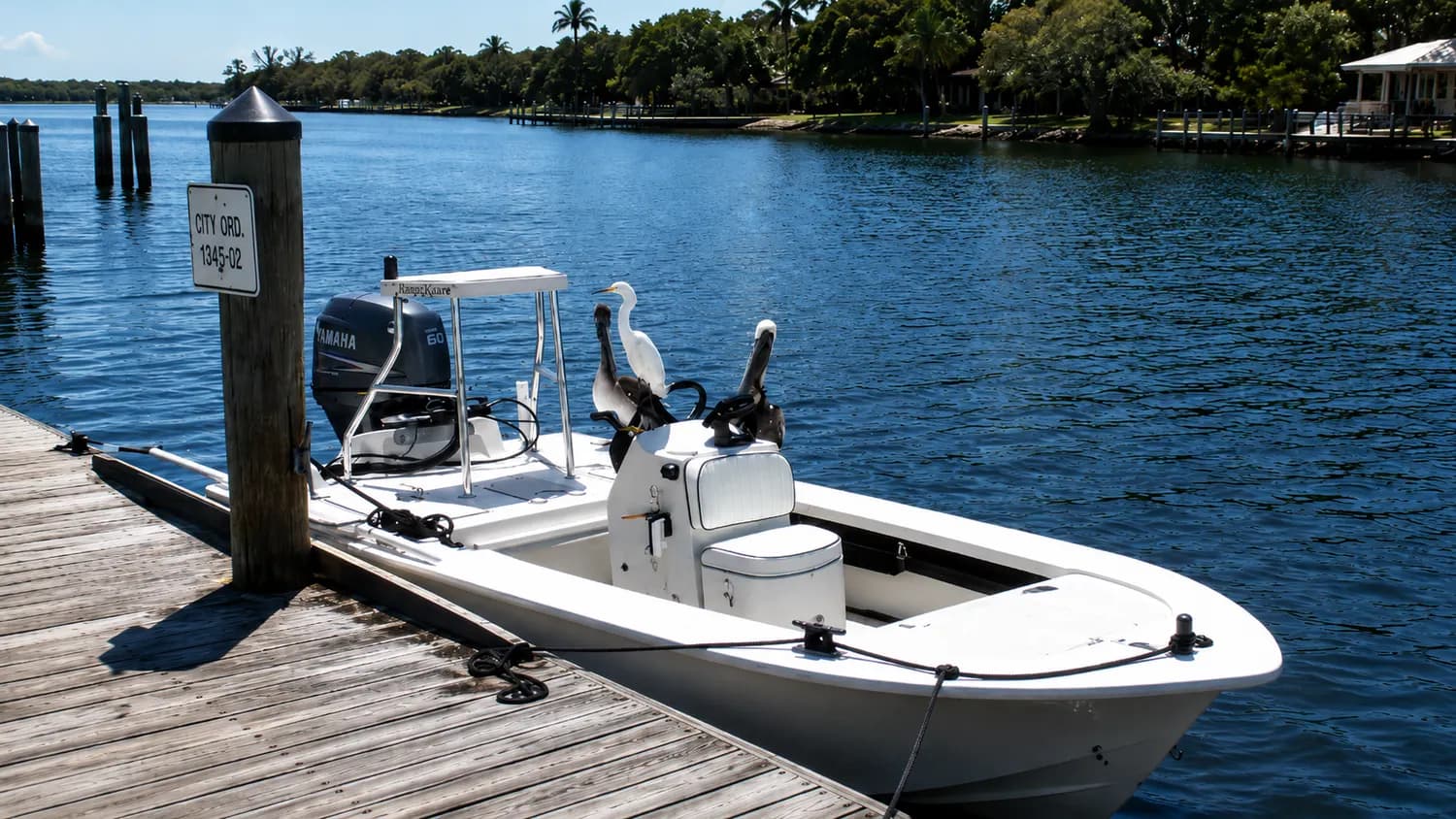 A bay boat tied up at the dock on a calm morning